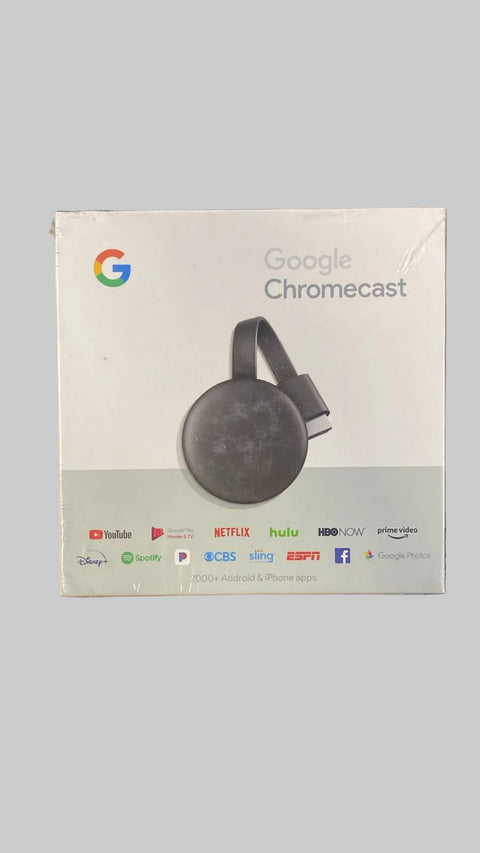 Google Chromecast box held in a hand with a blurred background